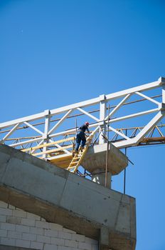 Construction worker with slabs of reinforced concrete