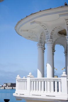 The white concrete gazebo in marine near the sea