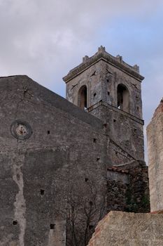 Old church belfry in Savoca village, Sicily, Italy in the evening