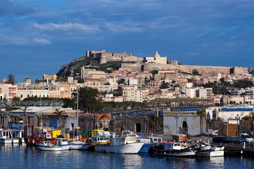 View from sea of Milazzo town in Sicily, Italy, with medieval castle on hilltop