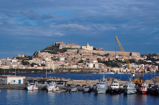 View from sea of Milazzo town in Sicily, Italy, with medieval castle on hilltop