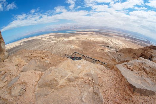 Fisheye view of desert landscape under Masada fortress near the Dead Sea