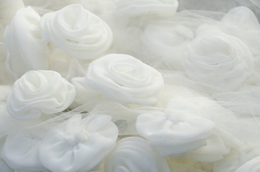 Close-up of beautiful and glowing white rose on wedding gown