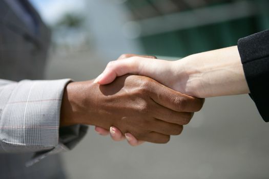 Interracial business hand-shake