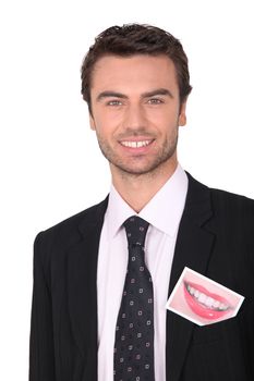 Smiling businessman with a photo of a woman's smile
