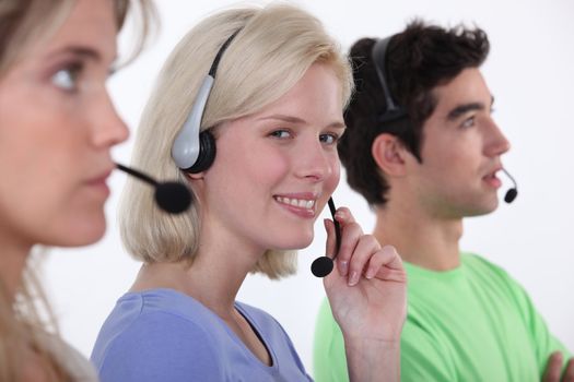 Three call-center workers sat in a row