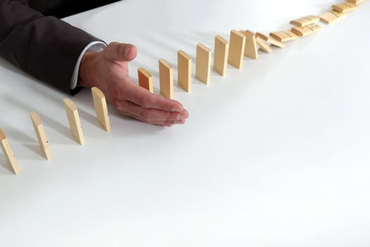 Hand of a man playing with dominoes