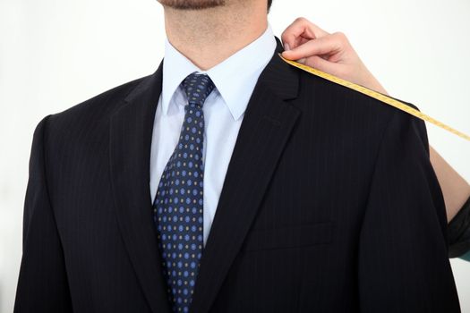 Businessman being measured for a suit