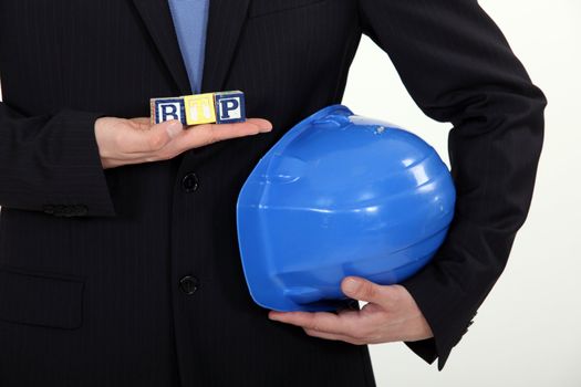 Female architect holding children's building blocks