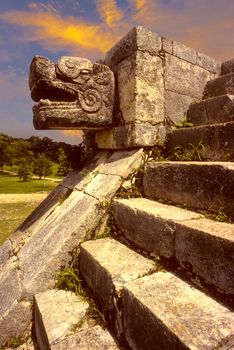 Snake head on steps of mayan temple at Chichen Itza, Mexico