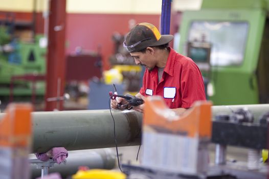 Machine shop worker quality testing steel tunes