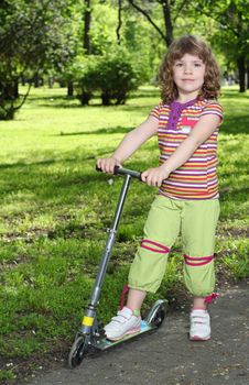 beautiful little girl with scooter posing