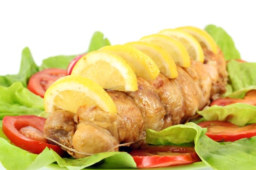 rolled chicken meat with lemon and salad