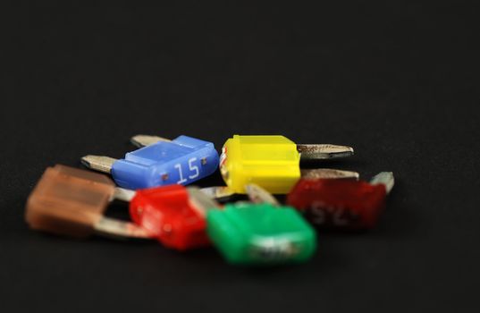electrical automobile fuses with shallow depth of field on black background