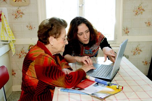 Woman helping grandmother with computer