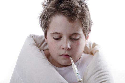 Young patient with fever, with digital thermometer and white blanket