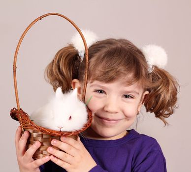 happy little girl with dwarf bunny pet