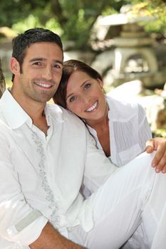 Couple sat relaxing in peaceful garden