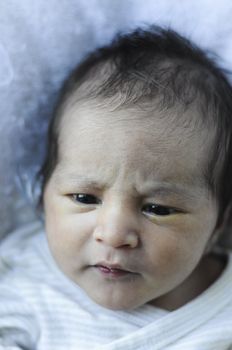 newborn baby looking with interest