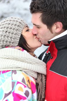 Couple kissing during winter holiday