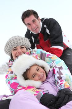 Family playing in the snow