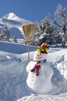 Snowman holding a broom