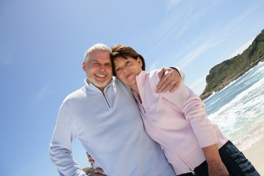 Old couple at the beach enjoying their retirement