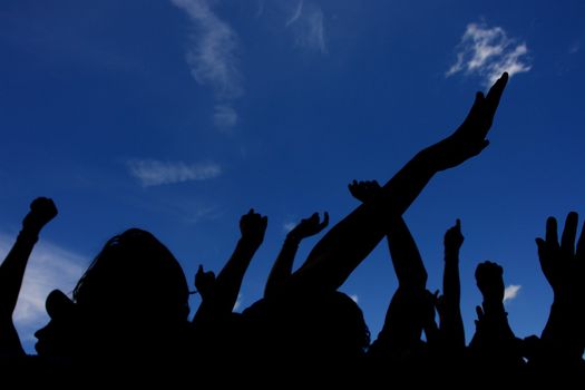 crowd with raised hands