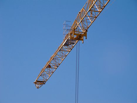 Detail of the jib of a yellow hoisting tower crane