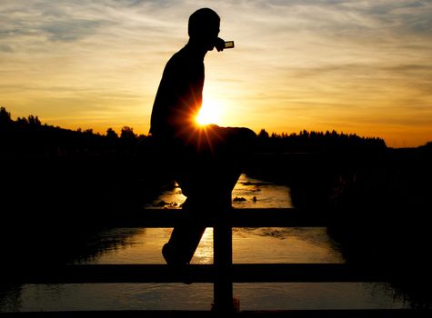 A person on a bridge making a photo