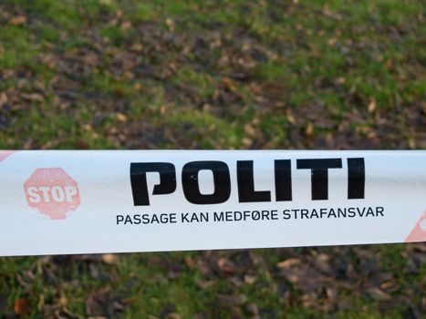 Politi, danish police barrier sign with meadow in background