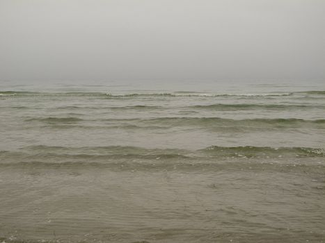 grey seascape with fog and waves in the baltic sea