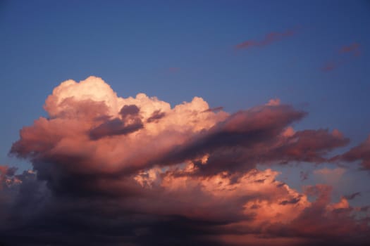 a huge storm lit by the setting sun.