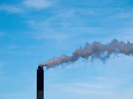 chimney smoke and blue sky in the background