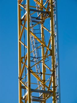Detail of the stairs of a yellow hoisting tower crane
