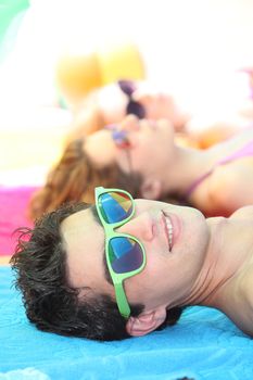 Teenagers lying on the beach