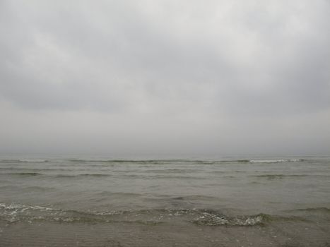 grey seascape with fog and waves in the baltic sea