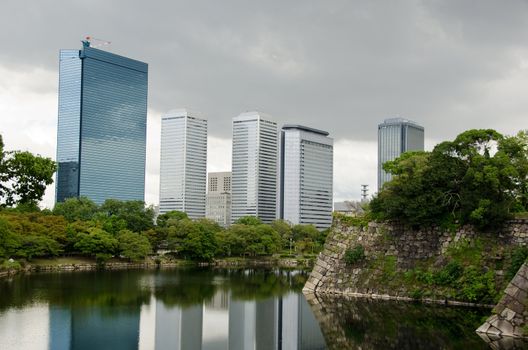 The Skyline of Osaka Business Park with the fortification walls of Osaka castle in the foreground