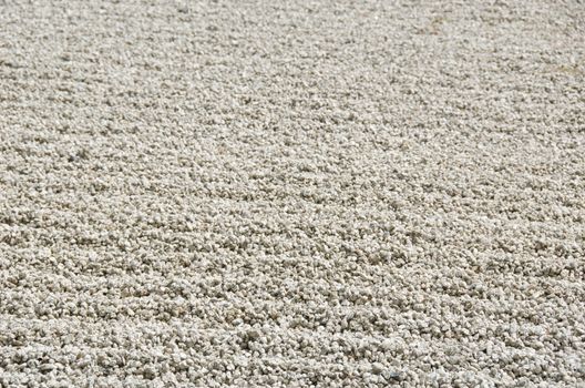 Stone garden of Zen Buddhism in Japan with gravel only, background structure