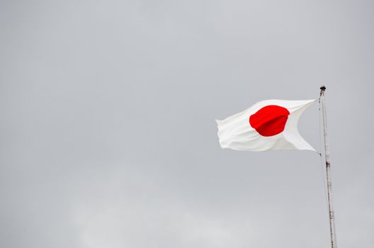 Japanese flag on flag pole in wind 