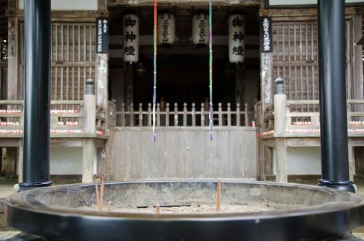 Japanese incense in front of a buddhist temple