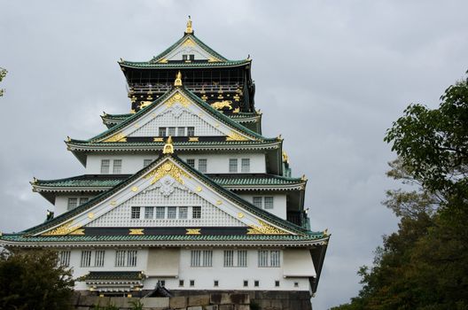 The Osaka castle in Japan in front of a cloudy sky