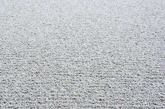 Background of gravel arranged in lines in a stone garden of a zen buddhist temple