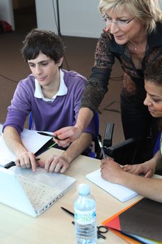 Female teacher assisting her pupils