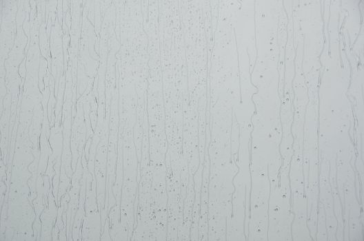 Closeup of water drops on a window when it is raining outside