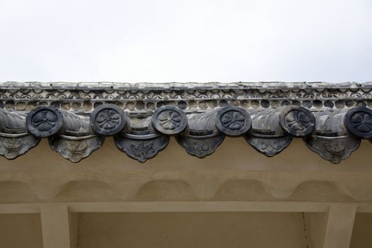 Closeup of round japanese roof tiles seen from below
