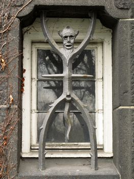 the devil as a window grate at the city hall in copenhagen; denmark