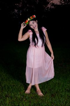 Asian Thai girl is holding flower crown in the park