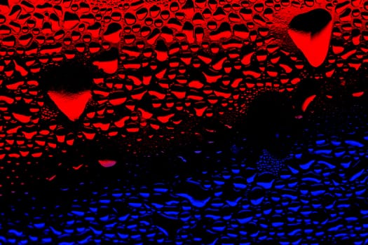 condensation red and blue water drops on a plastic surface