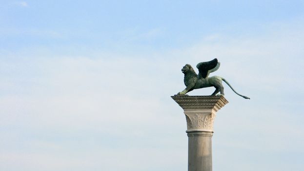 the winged lion of St mark in front of the Doge's palace in venice